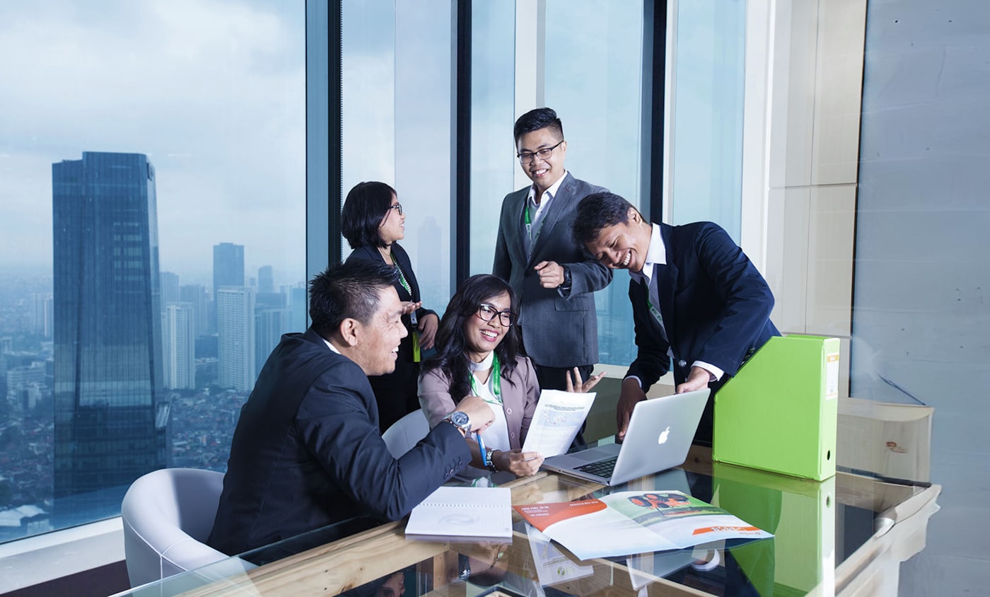 Ascelex advisors in a boardroom meeting in Singapore, overlooking the CBD skyline