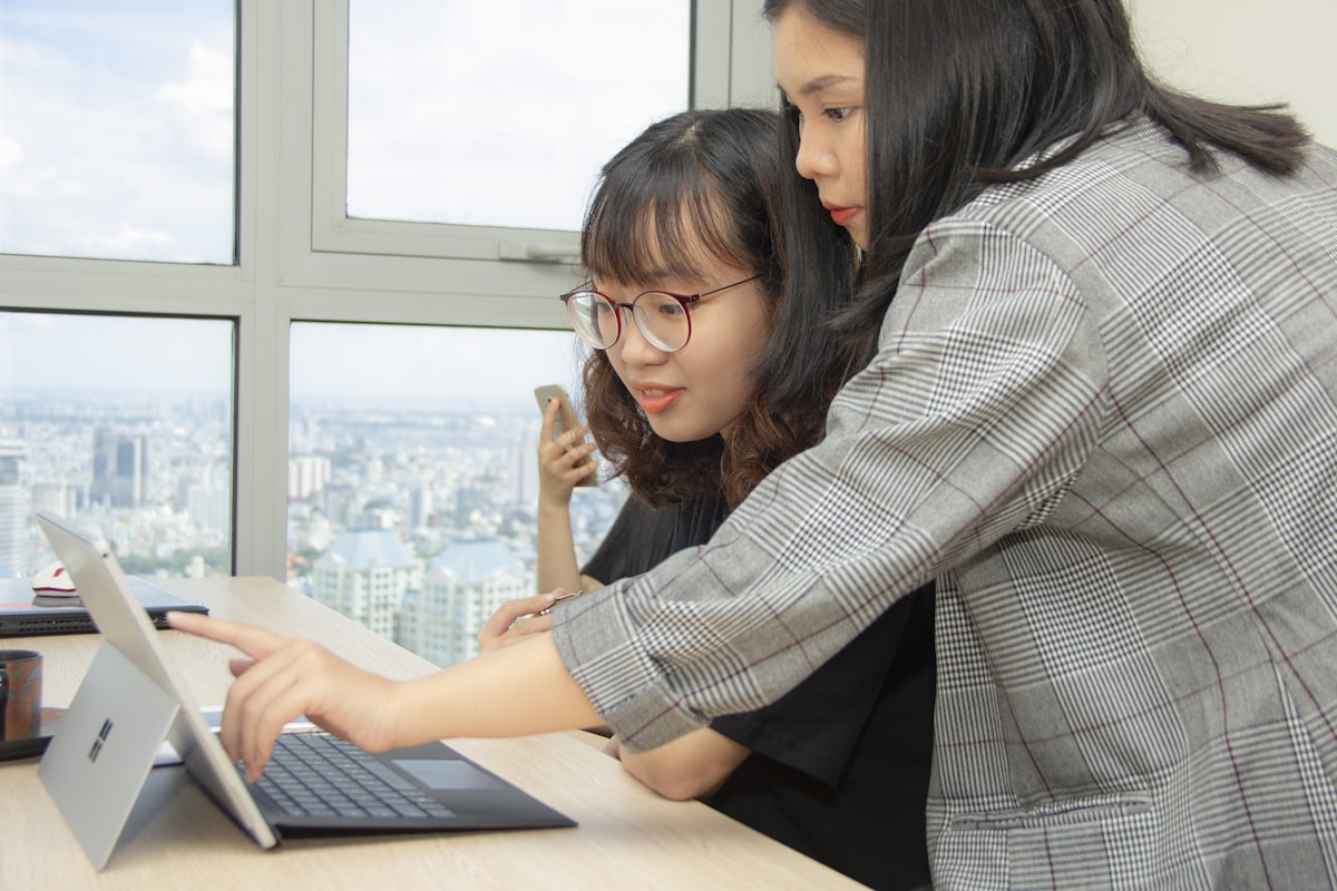 Two Ascelex advisors collaborating in a Singapore high-rise office